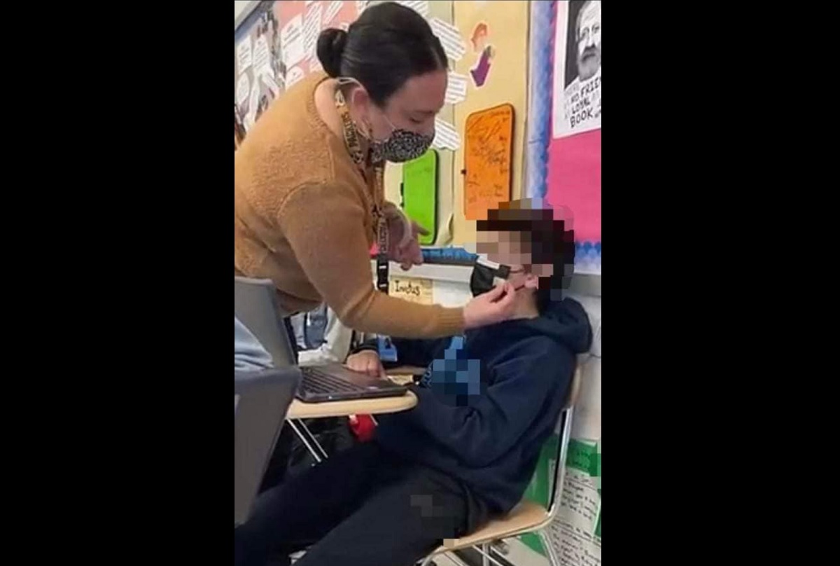 Foto de professora pregando a máscara no rosto do aluno causa indignação na internet
